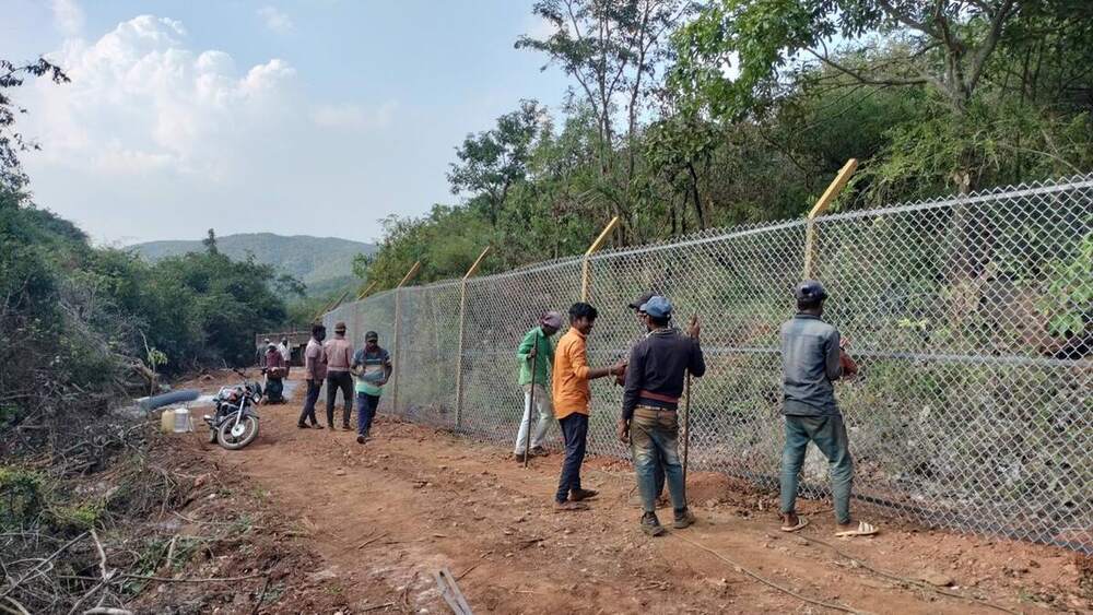Our crew along a finished chain link fence