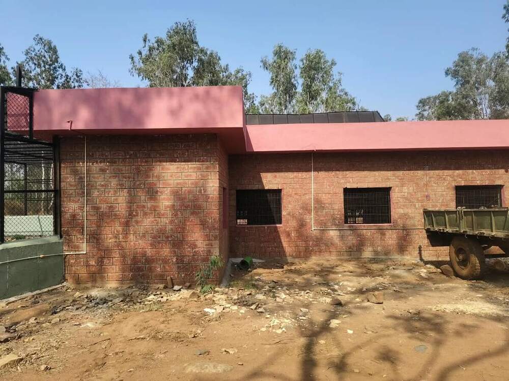 Stone clad service building with roof finishing in progress